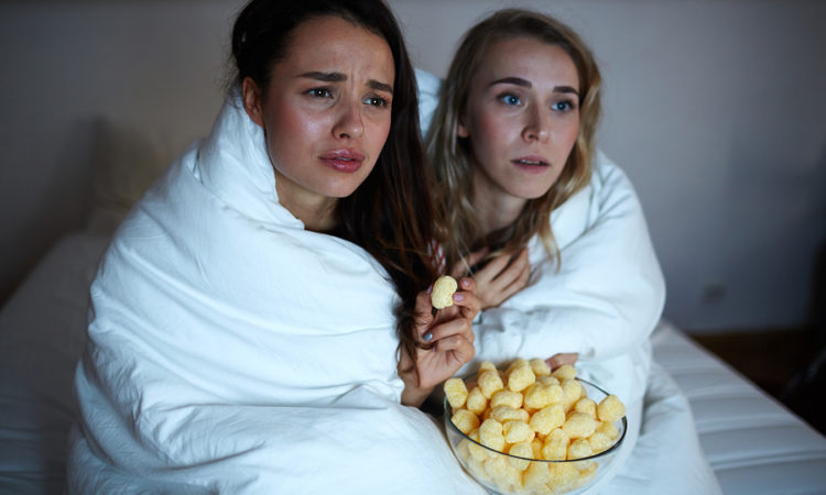 Emotional girls wrapped into blanket