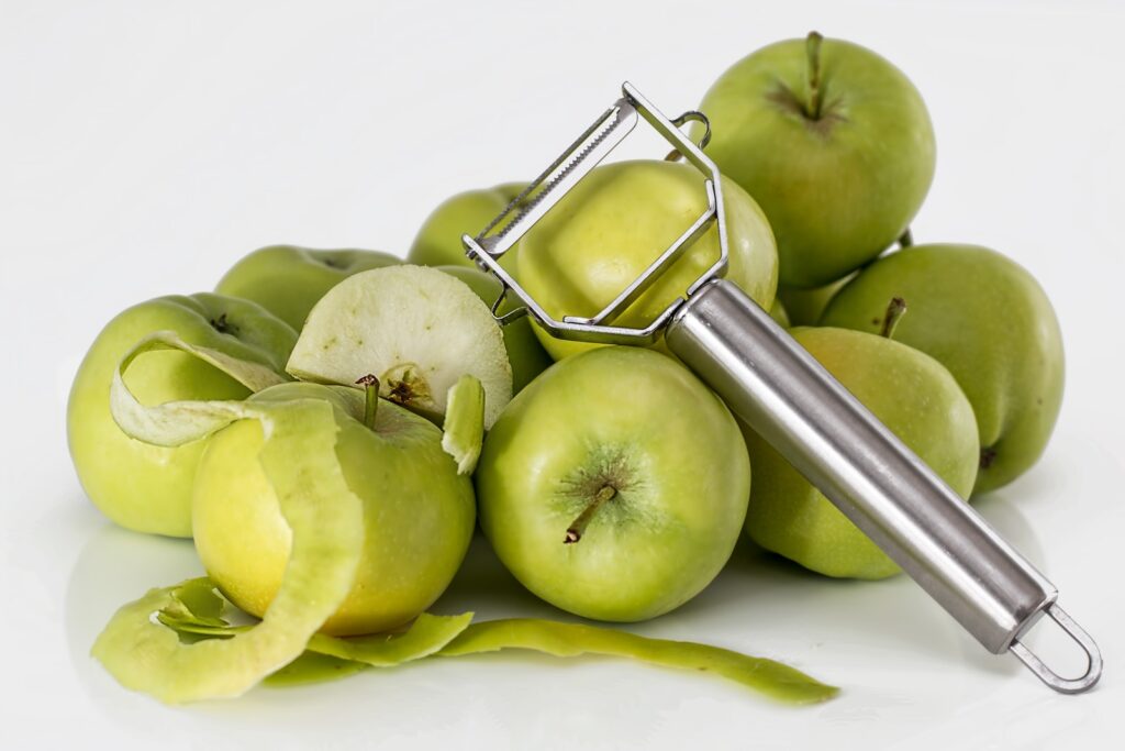 Green Unripe Apple With Silver Peeler