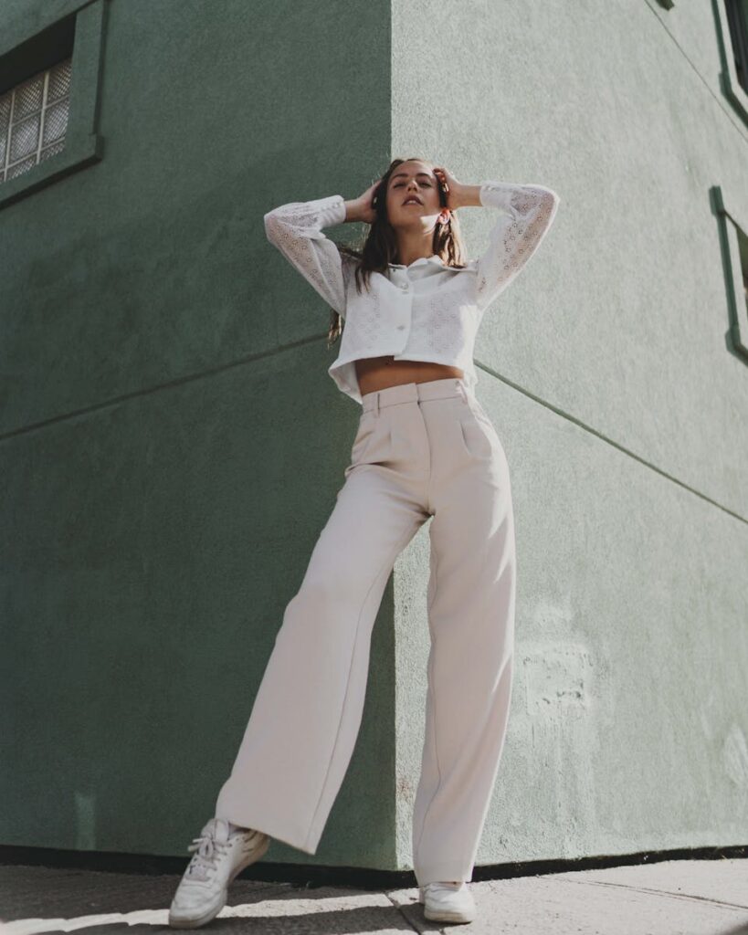 A Woman Wearing a White Long Sleeved Shirt and Wide Leg Pants