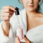 Close-up of Woman Holding a Cosmetic Product with a Pipette